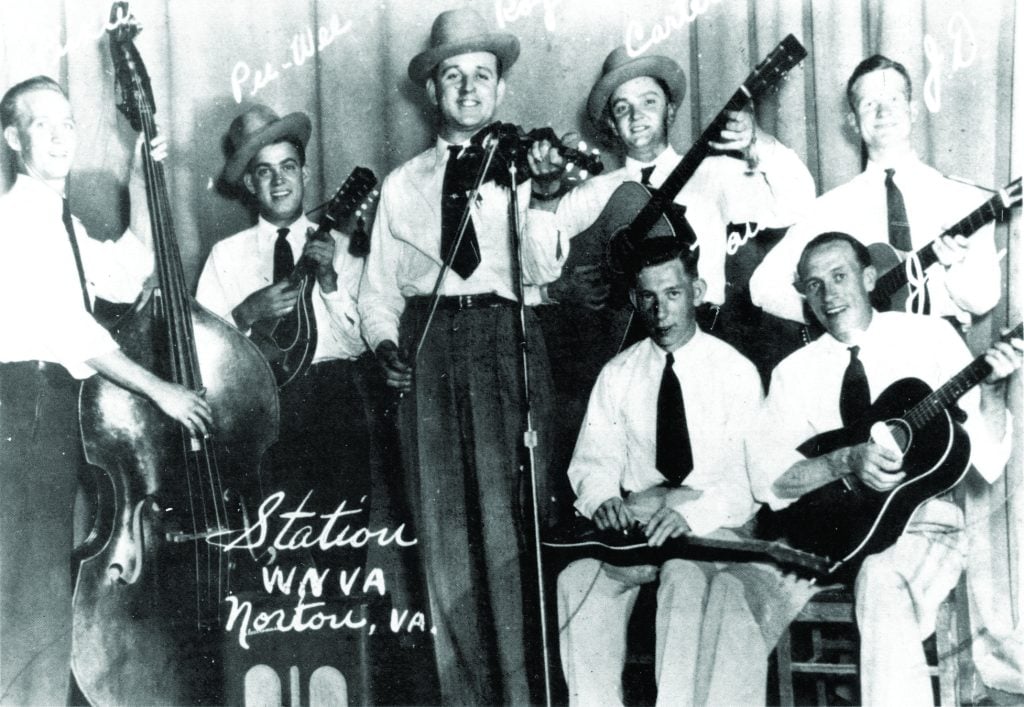  Roy Sykes and the Blue Ridge Mountain Boys. Although the photo is engraved with the call letters for Radio Station WNVA, the photo was taken on the stage of the high school in St. Paul, Virginia. Standing, from left to right: Ray Lambert, Pee Wee Lambert, Roy Sykes, Carter Stanley, J. D. Richards. Seated, left to right: Gaines Blevins and Jack Belcher, ca. mid-1946. Photo courtesy of Roy “Scooter” Sykes, Jr.