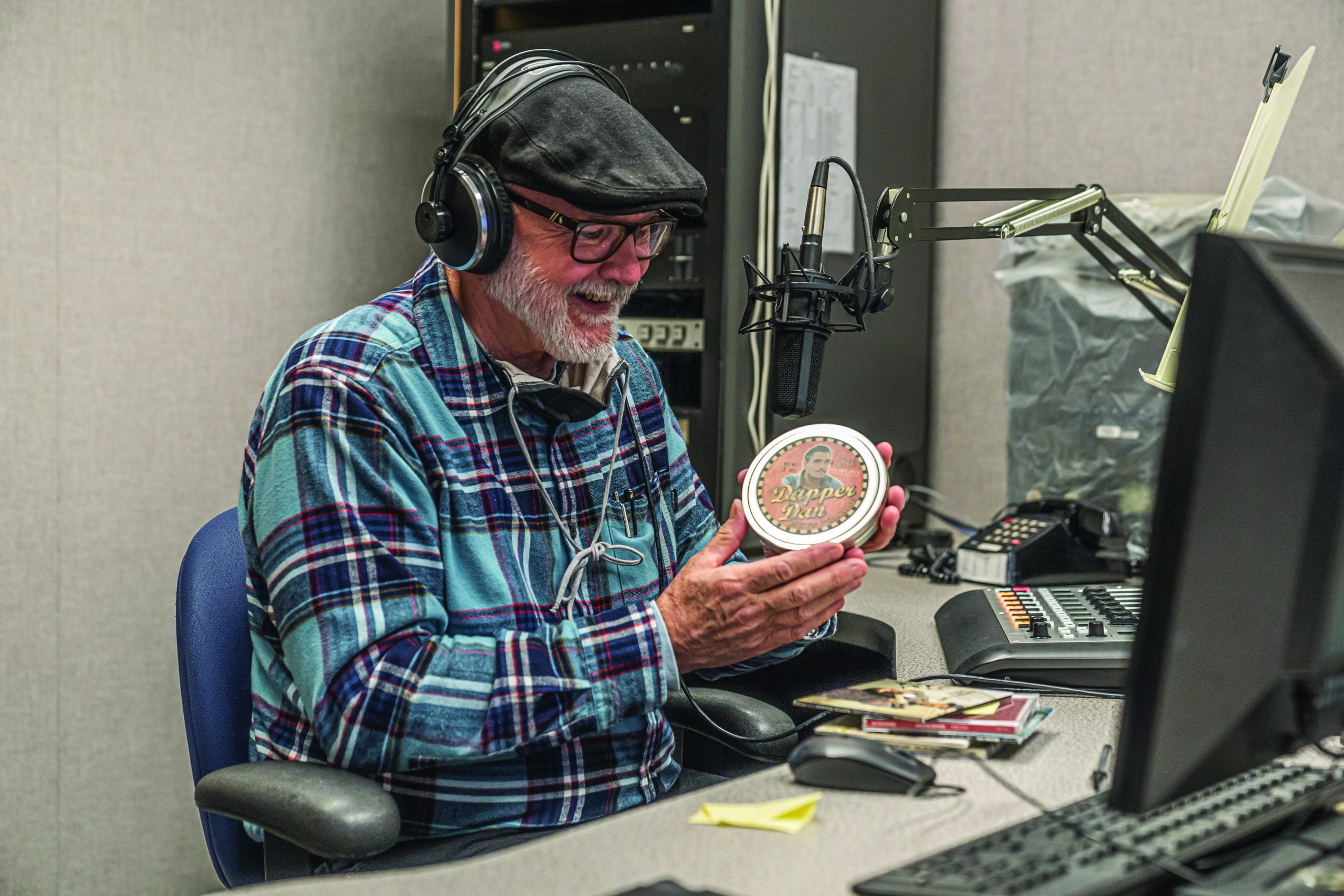 Mike Smith at the KSMU Studios—holding a can of Dapper Dan Pomade—was the first DJ in America to play the O Brother Where Art Thou soundtrack. Photo by Steven Spencer.