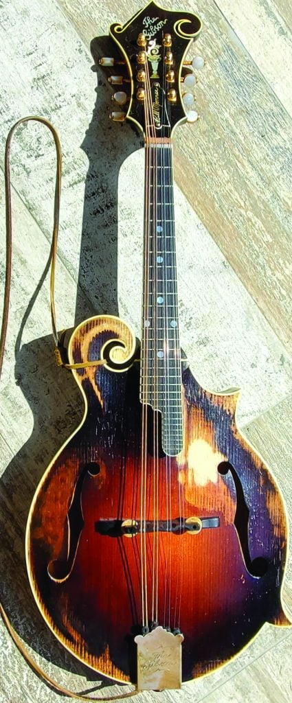 Monroe Model Mandolin sitting on a wooden table