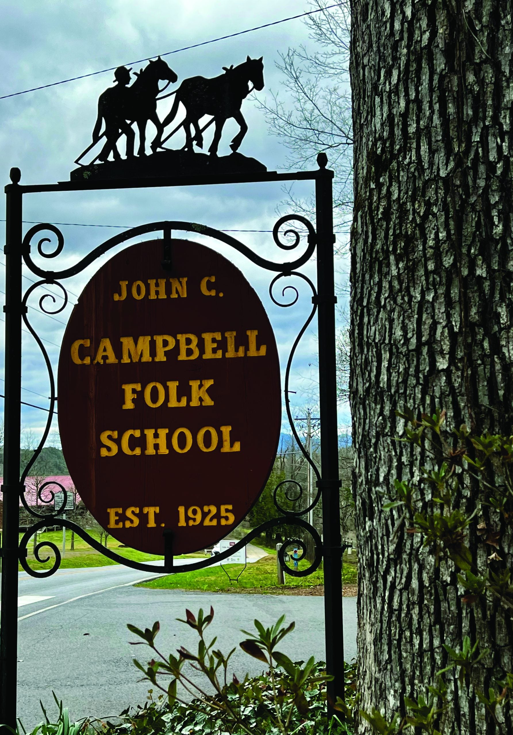 A forged metal sign hangs at the entrance of the John C. Campbell Folk School.  Photo by Vicki DeanA forged metal sign hangs at the entrance of the John C. Campbell Folk School.  Photo by Vicki Dean