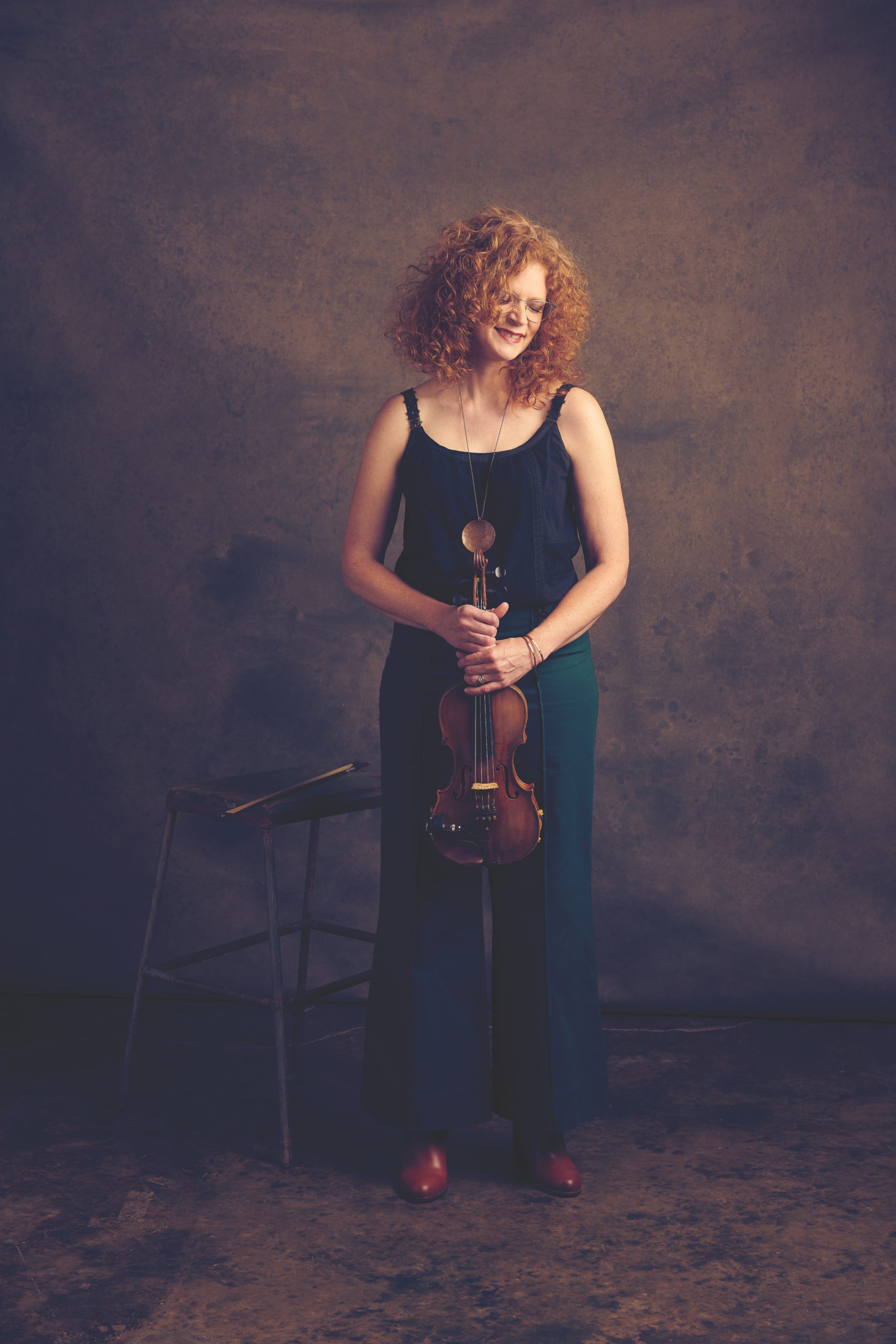 Becky Buller poses for a professional photo with her instrument