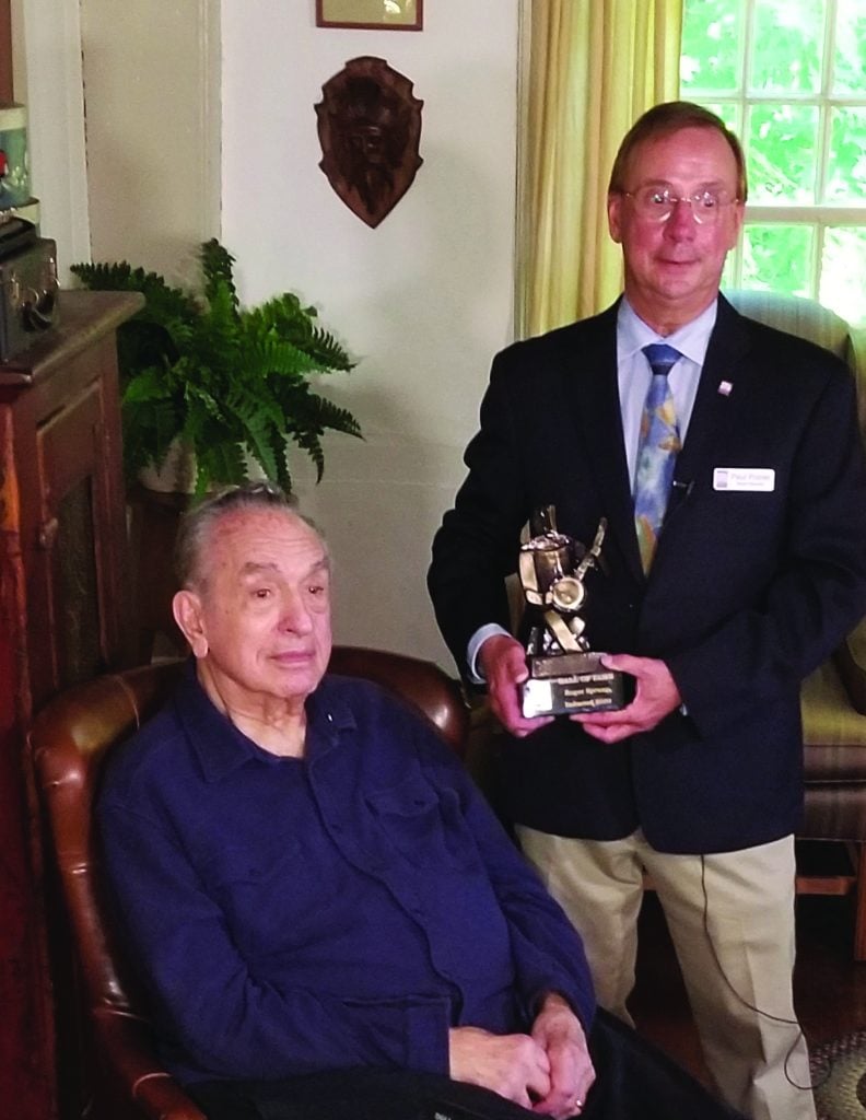 Roger Sprung receiving his Banjo Hall of Fame statue from Paul Poirer