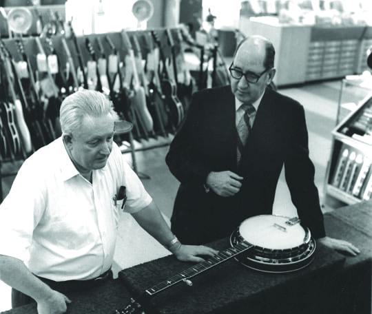 Gibson executive Wilbur Marker shows Amos Arthur the new production Gibson RB-250