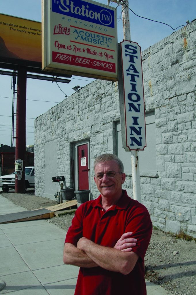 JT Gray stands with his arms crossed across his body while smiling for a photo