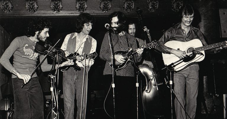 The David Grisman Quintet performing on stage together in 1979