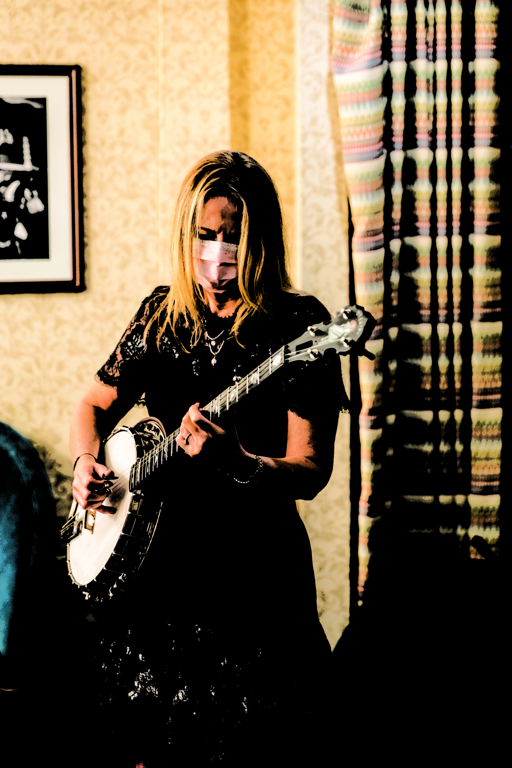 Alison Brown plays banjo in hotel room