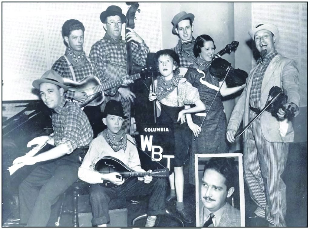 Billie Burton Daniel – at center behind WBT banner – with the Briarhoppers in 1936. Photo courtesy of Tom Warlick.