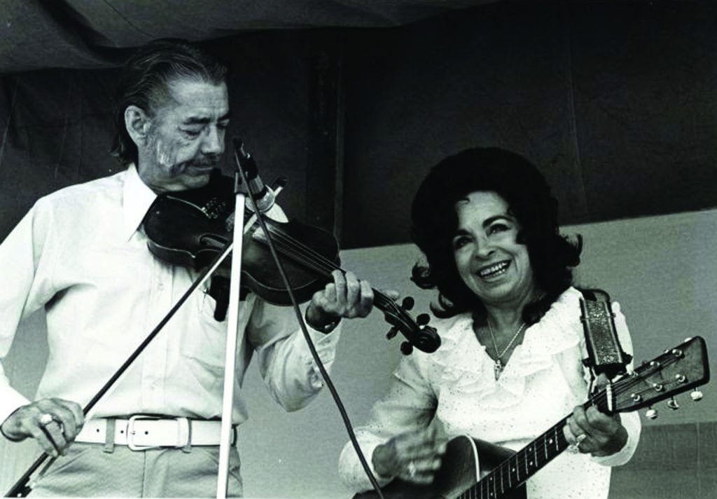Stoney Cooper working the fiddle with Wilma Lee. Photo courtesy of West Virginia and Regional History Collection.