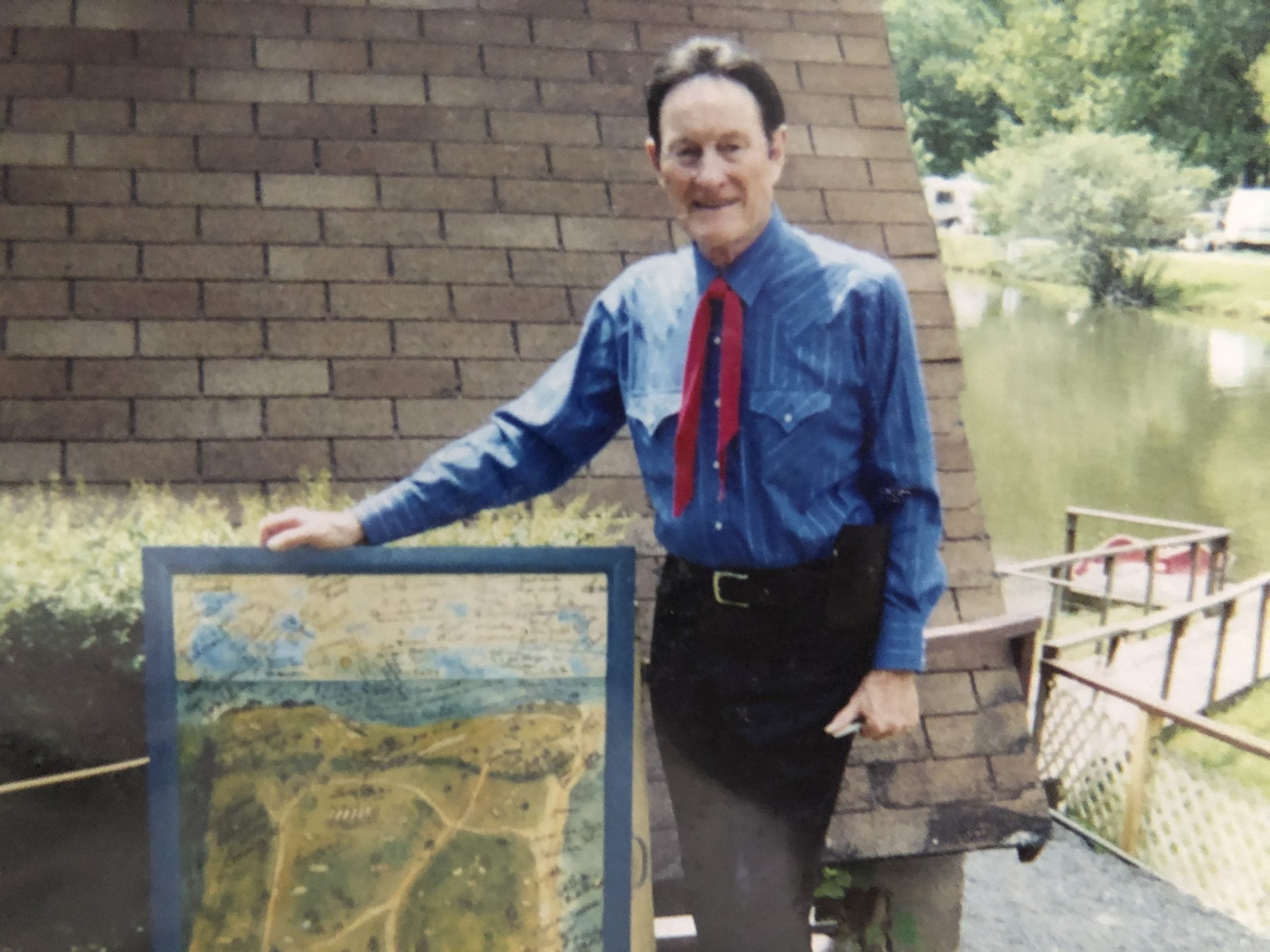 Jesse McReynolds stands next to the camper door panel