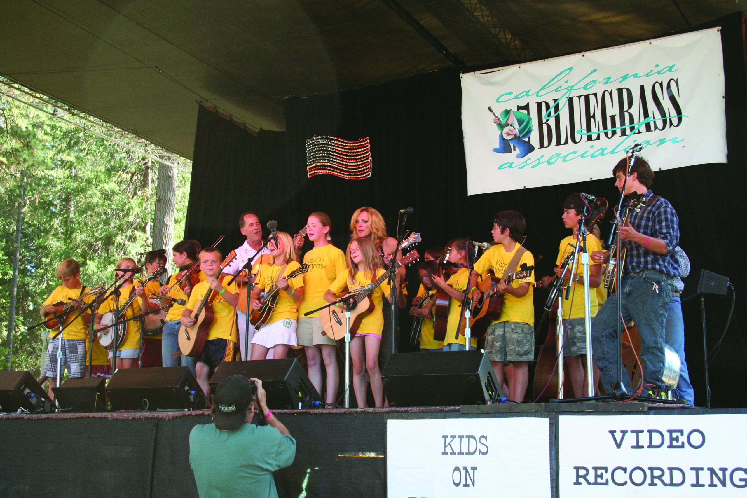 The Kids On Bluegrass perform on stage with Wayne Taylor (of Country Current) and Rhonda Vincent.  Photo by dan miller