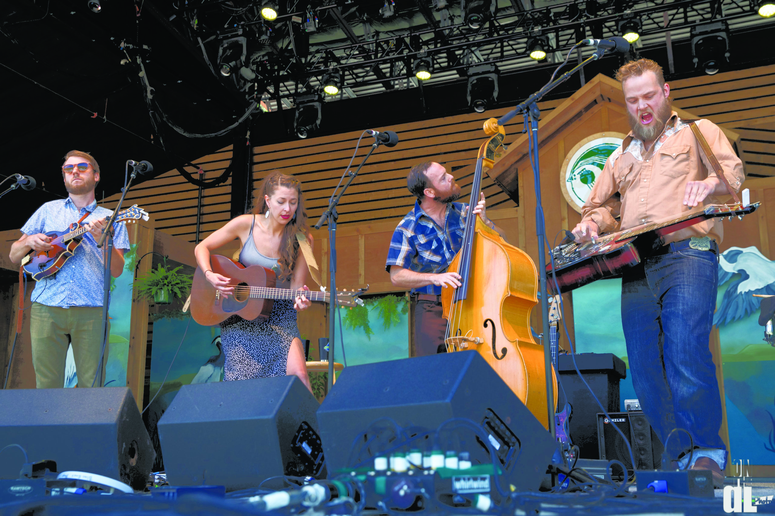Lindsay Lou and the Flatbellys perform on stage with their instruments