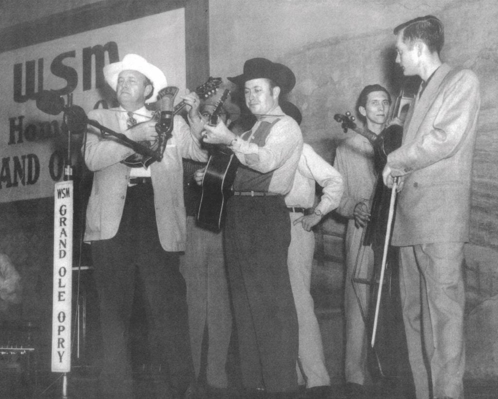 Martin & Monroe playing their instruments on stage together