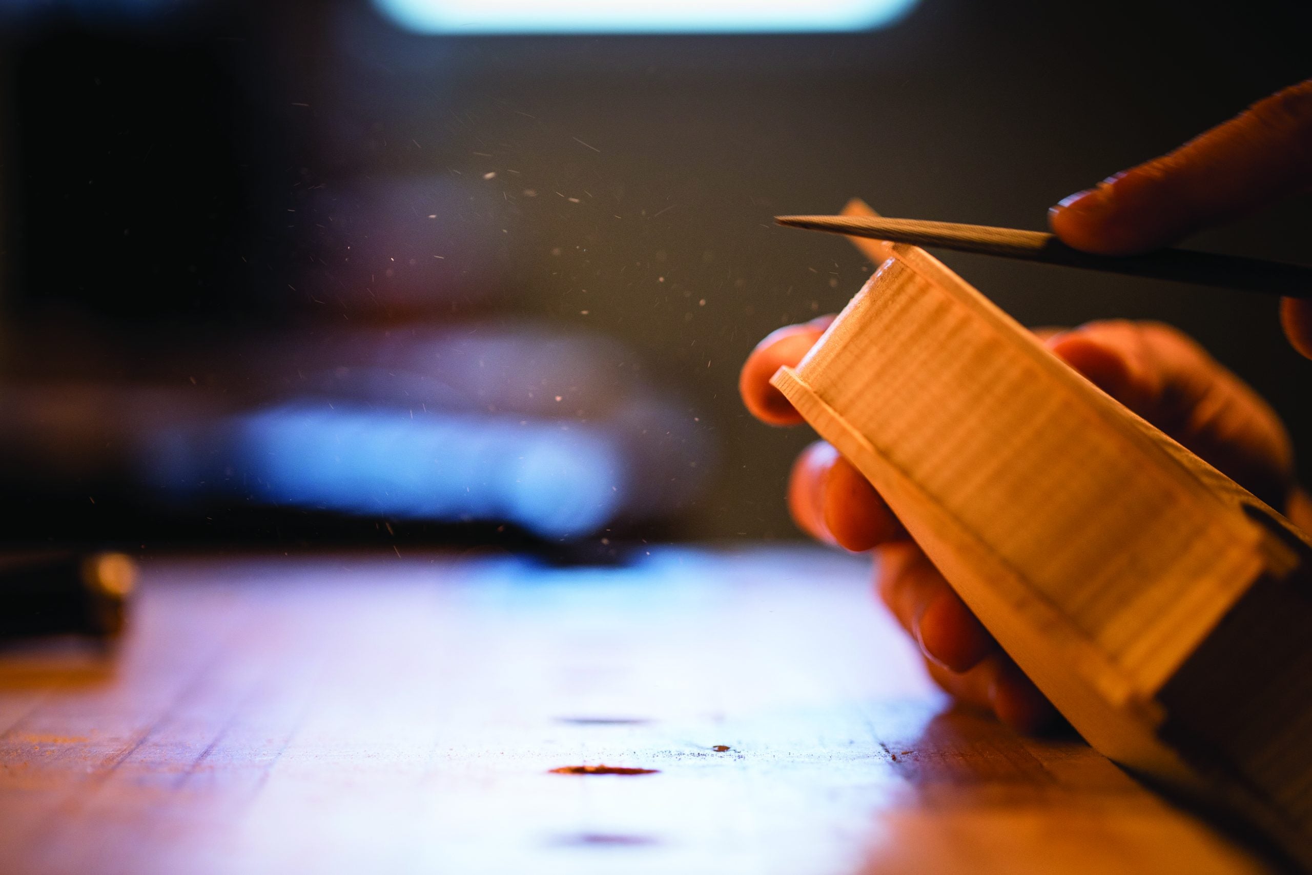 Close up shot of a violin in the process of being carved