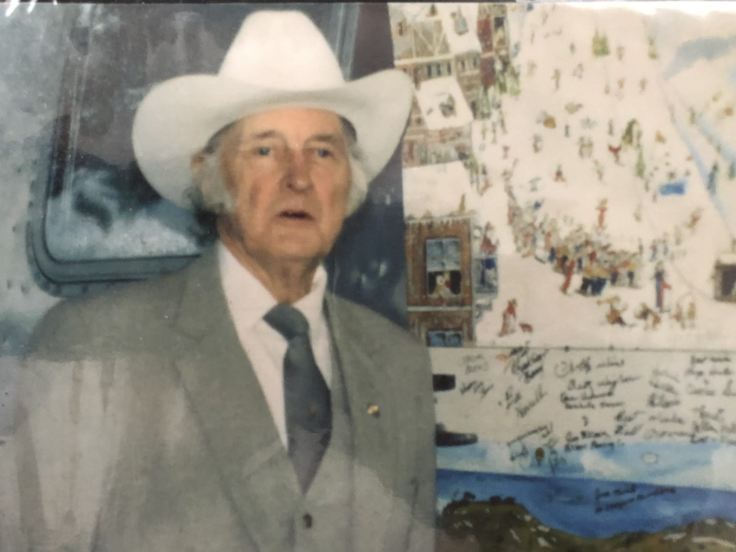 Bill Monroe poses for a photo after signing