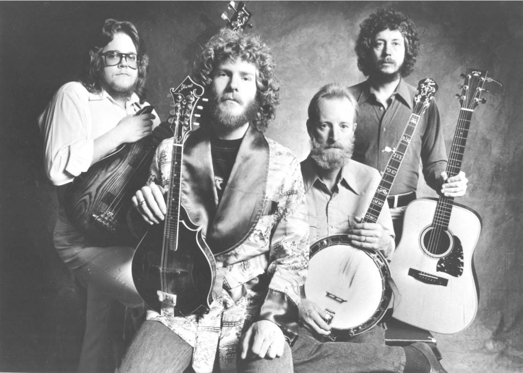 The New Grass Revival group pose together with their instruments.