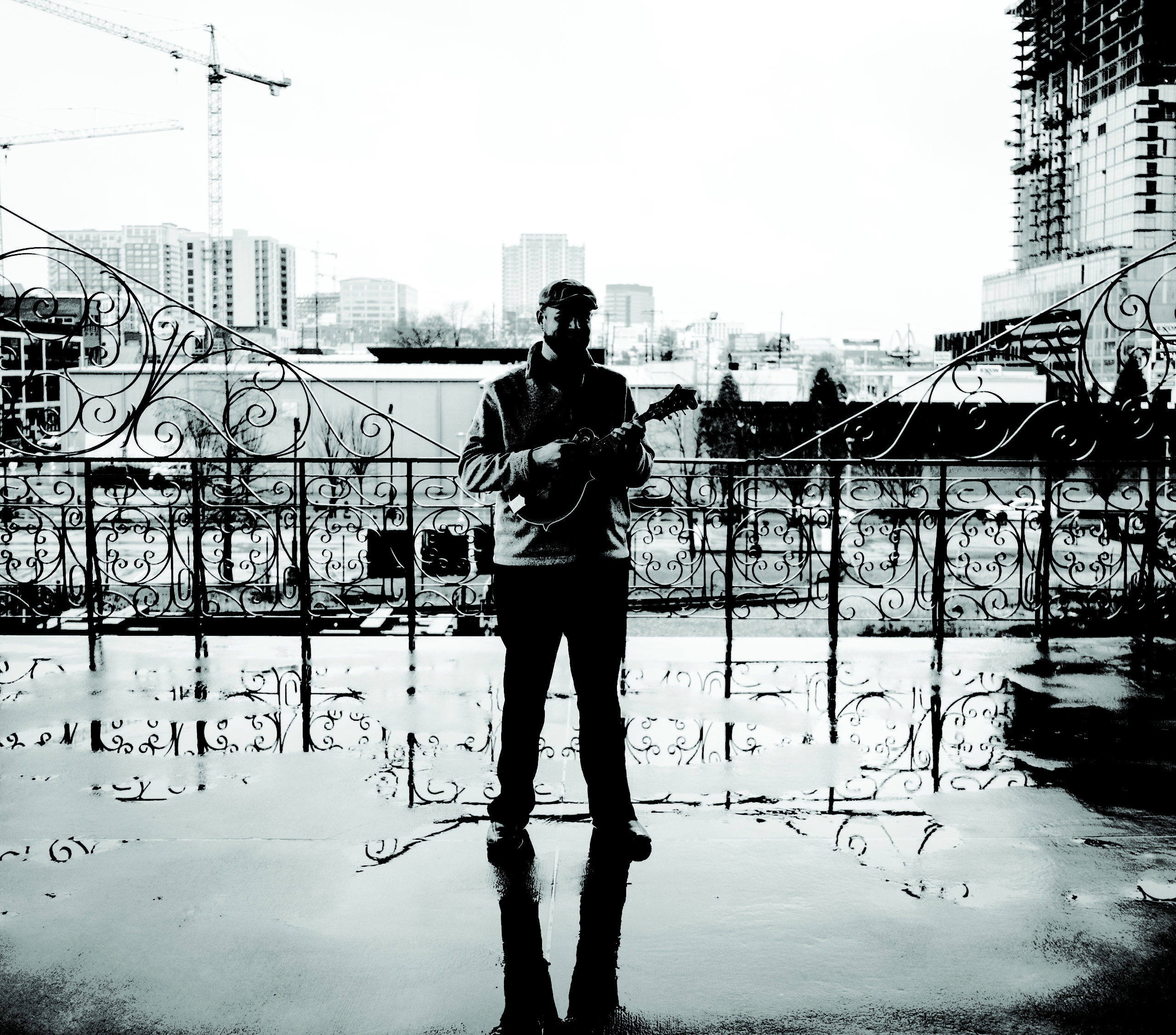 Nate Lee smiles on a rainy day with his instrument in hand