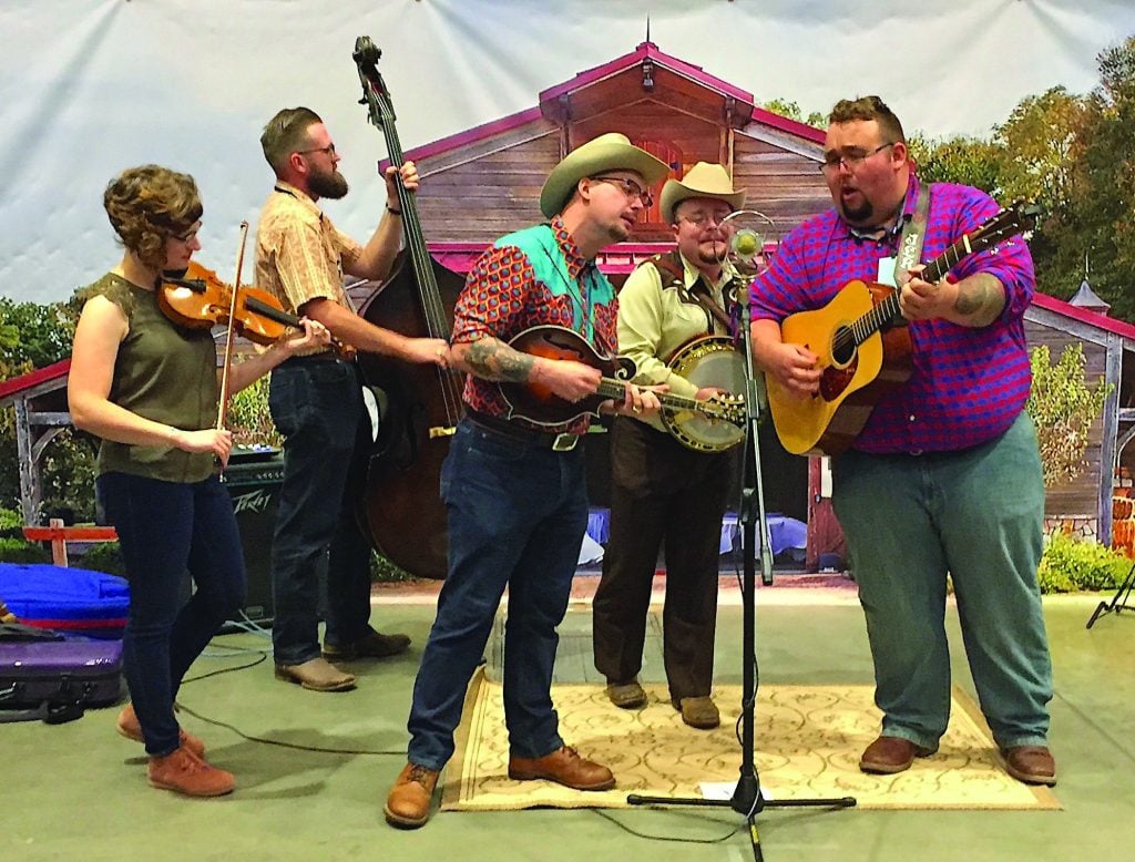 Po’ Ramblin’ Boys performing in the exhibit hall at the 2019 IBMA World of Bluegrass.  L to R: Laura Orshaw, Jasper Lorentzen, C.J. Lewandowski, Jereme Brown, Josh Rinkel. photo by Penny Parsons