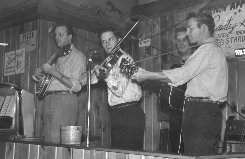 Pete playing the fiddle with other members of the Country Gentlemen