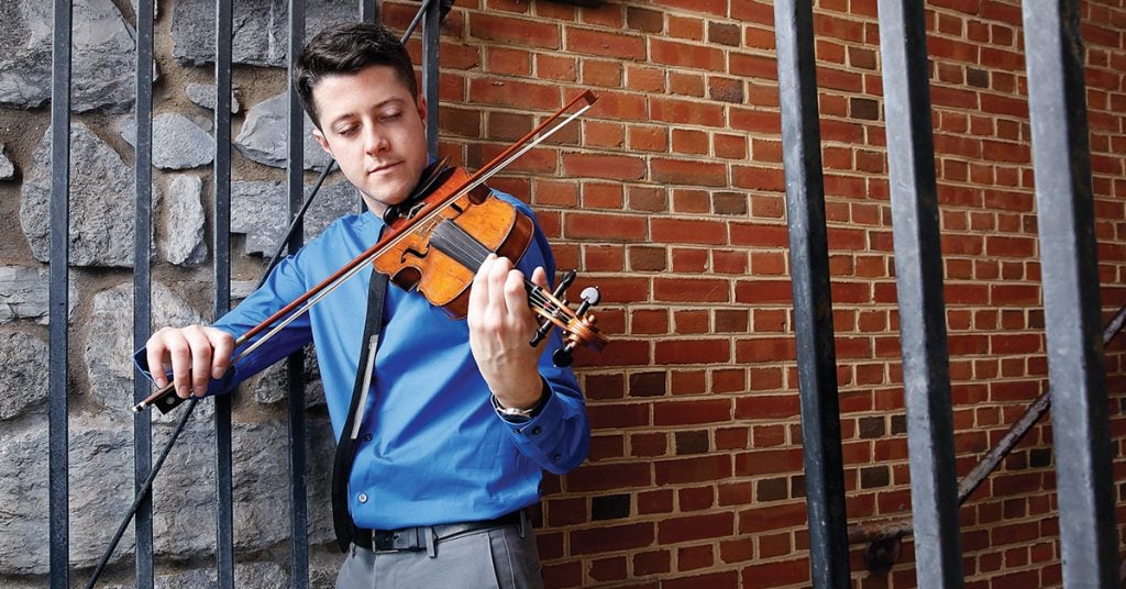 Patrick McAvinue plays violin outdoors