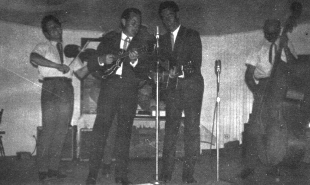 Black and white photo of Jim and Jesse performing on stage