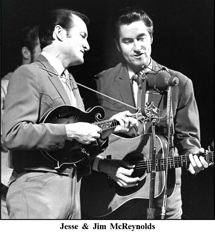 Jesse & Jim McReynolds performing on stage together.