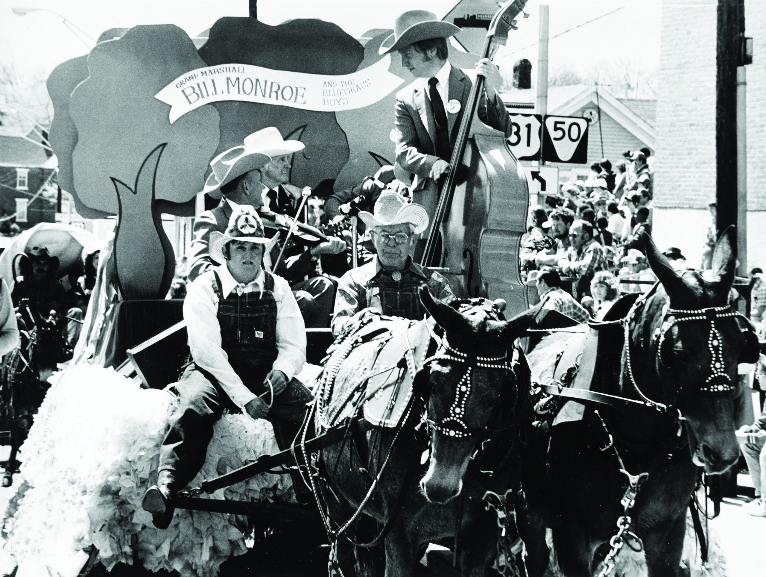The Blue Grass Boys are towed in a wagon at the annual Mule Day Parade in Columbia, Tennesse. Hembree discovered playing bass amid the mules’ jerking stops and starts was far from easy.
