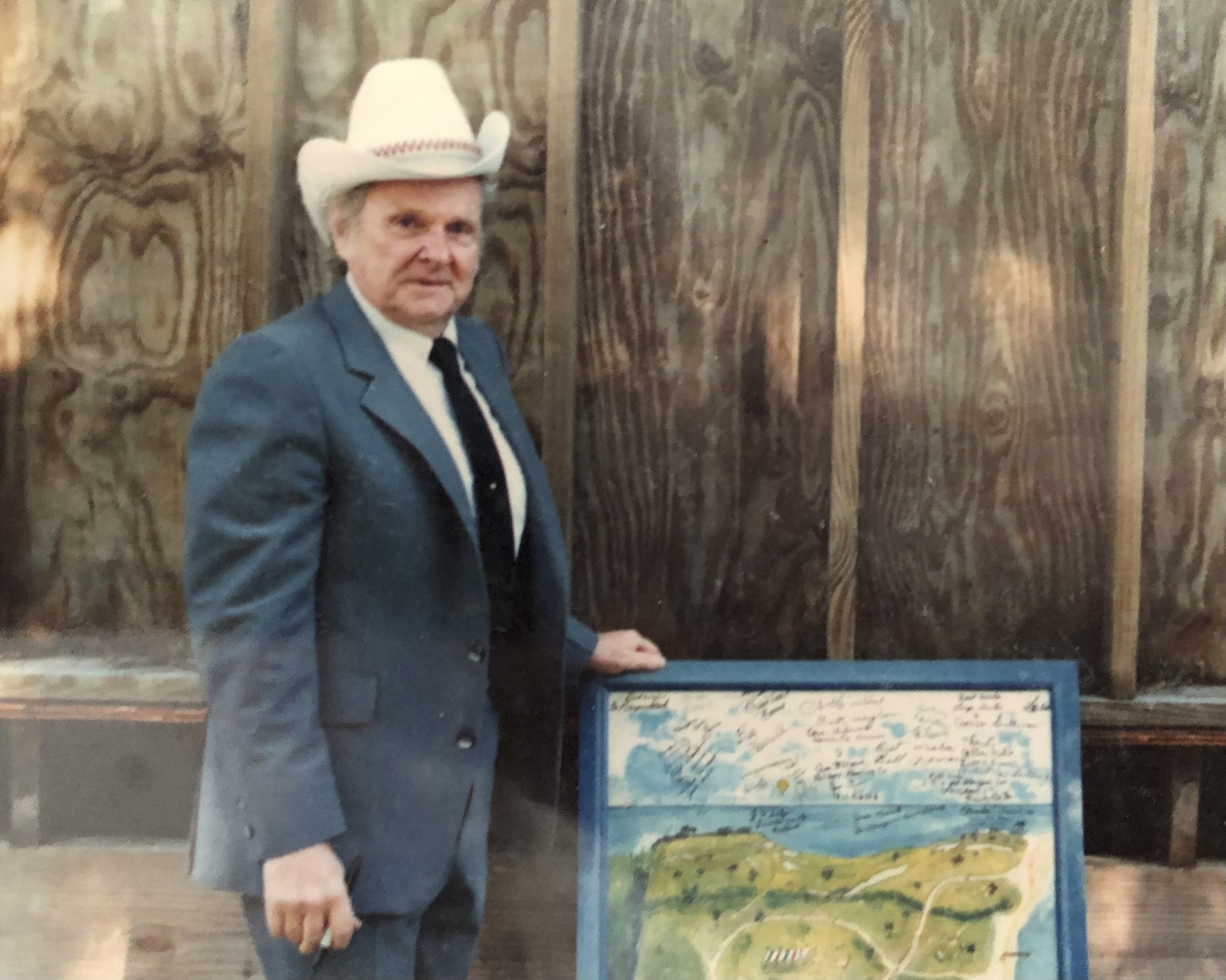Dr. Ralph Stanley stands with pen in hand just after signing