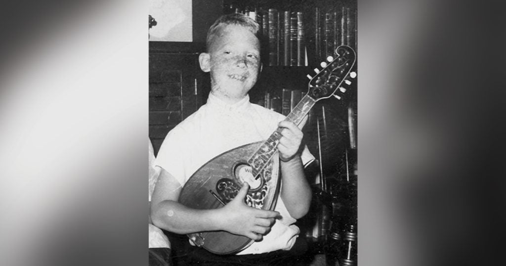 Tom Mindte with his first mandolin (age 8)