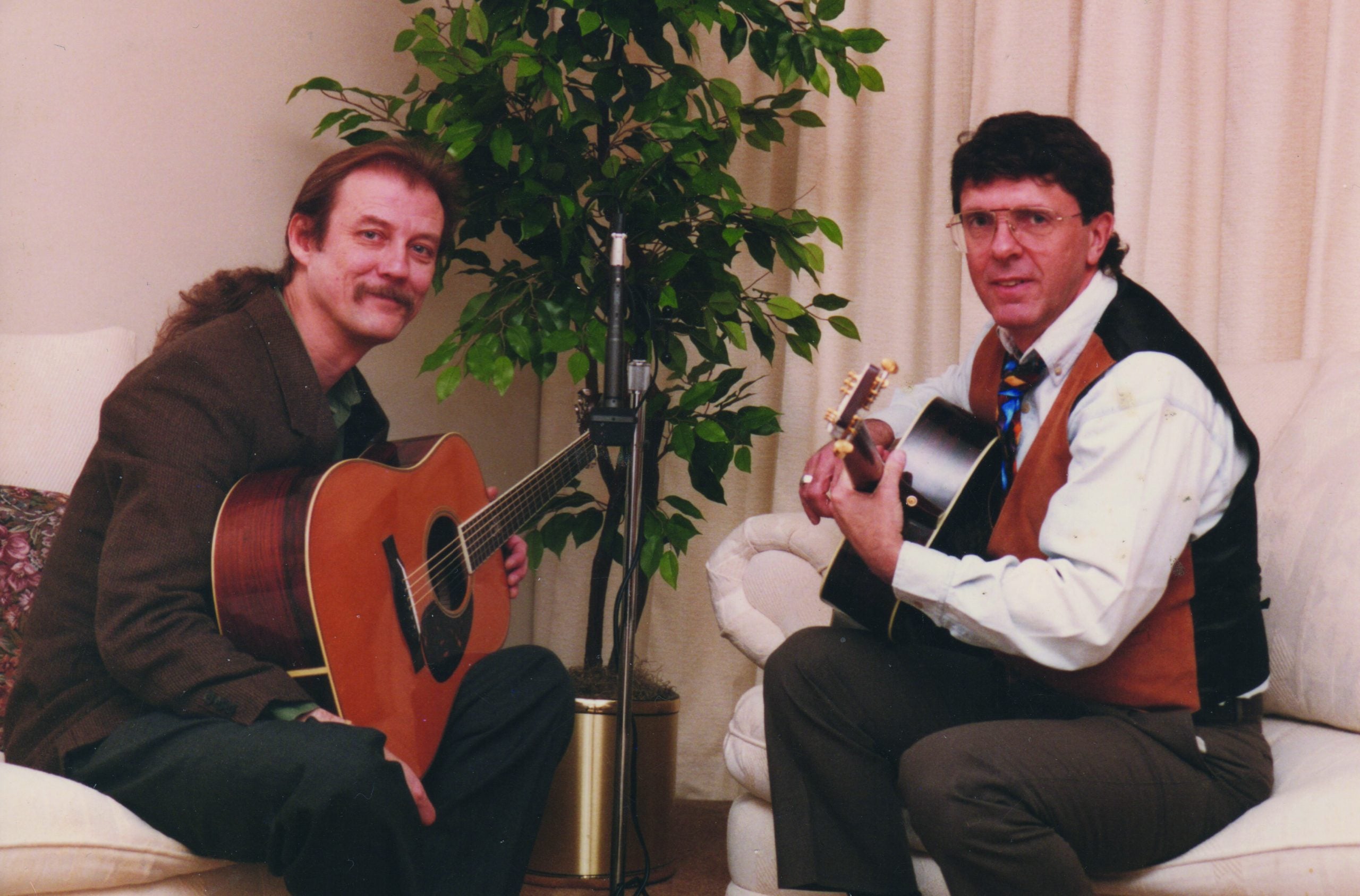 Tony Rice and John Carlini smile for a photo.