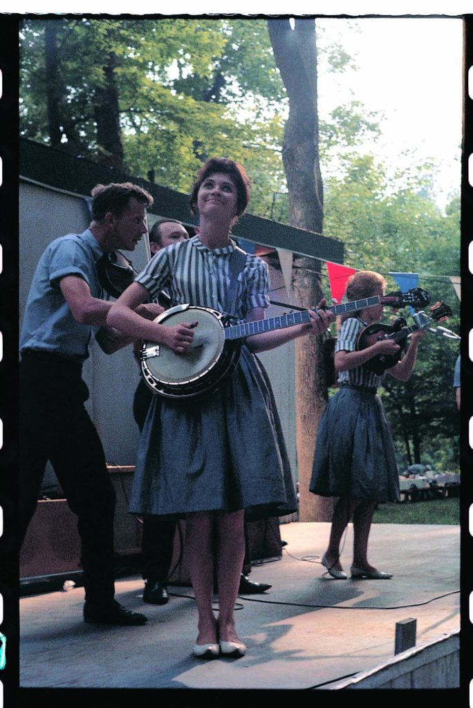 Scotty, Roni & Donna Stoneman play instruments on stage