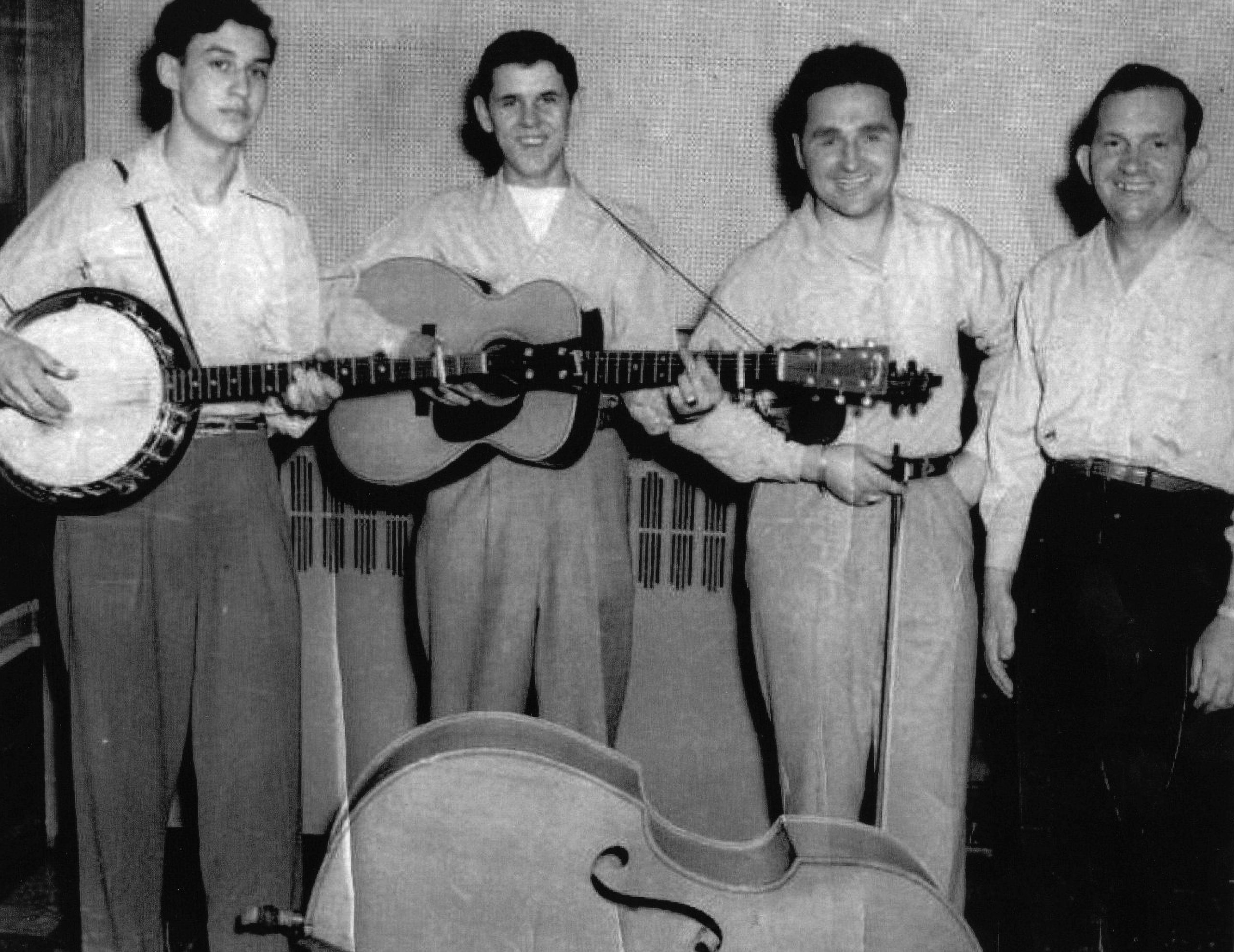 The Lonesome Pine Fiddlers—Taken circa 1953 at WLSI RADIO - Pikeville, Kentucky.  From left to right, Ray Goins, Paul Williams, Curly Ray Cline, Ezra Cline. //  Photo donated by Scotty Cline, courtesy of the Bluegrass Music Hall of Fame & Museum.