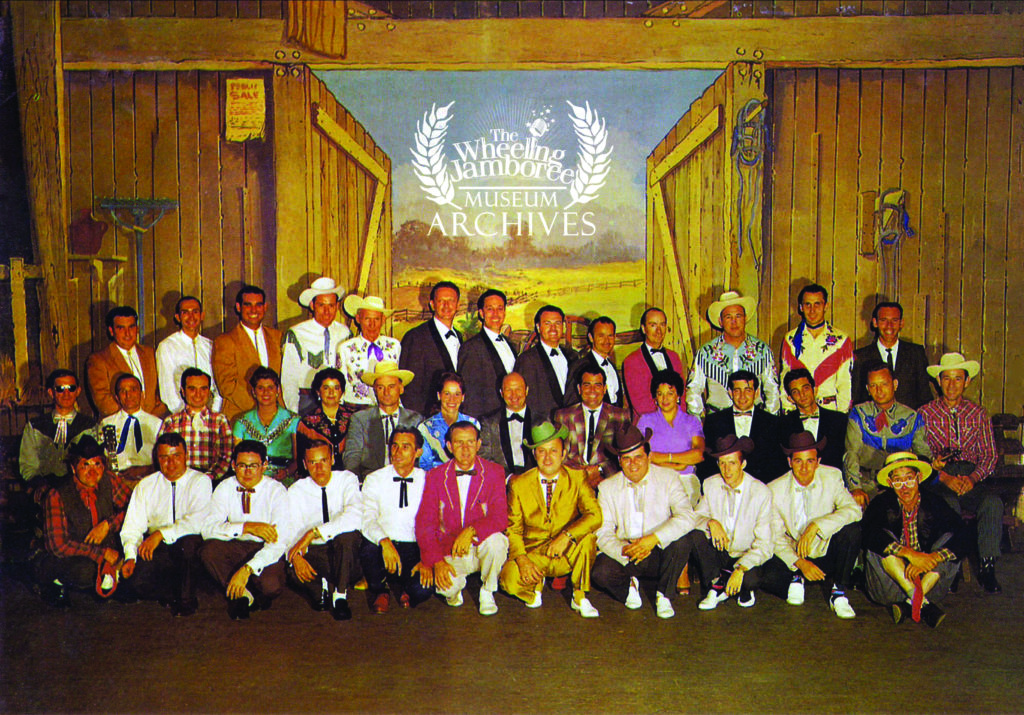 1959 WWVA Jamboree Cast: 
Back row (left to right): Bobby Osborne, Jimmy Brown, Sonny Osborne, Roy Scott, Big Slim, Ace Richman, Burl Strevel, Fred Daniels, Eddie Wallace, John Corrigan, Lee Moore, Mike Harris, Tater Tate

Middle row l-r: Marion Martin, Abner Doolittle, Monty Blake, Lynn Gibson, Chickie Williams, Doc Williams, Louella Perkins, Hardrock Gunter, Jimmy Blaney, Bonnie Baldwin, Rusty Kershaw, Doug Kershaw, Buddy Durham, Ebb Collins; 

Front row l-r, Crazy Elmer, Billy Edwards, Norman Blake, Bill Lowe, Melvin Goins, Hylo Brown, Jimm Martin, Paul Williams, J.D.Crowe, Herb Hooven, Zeb Collins.