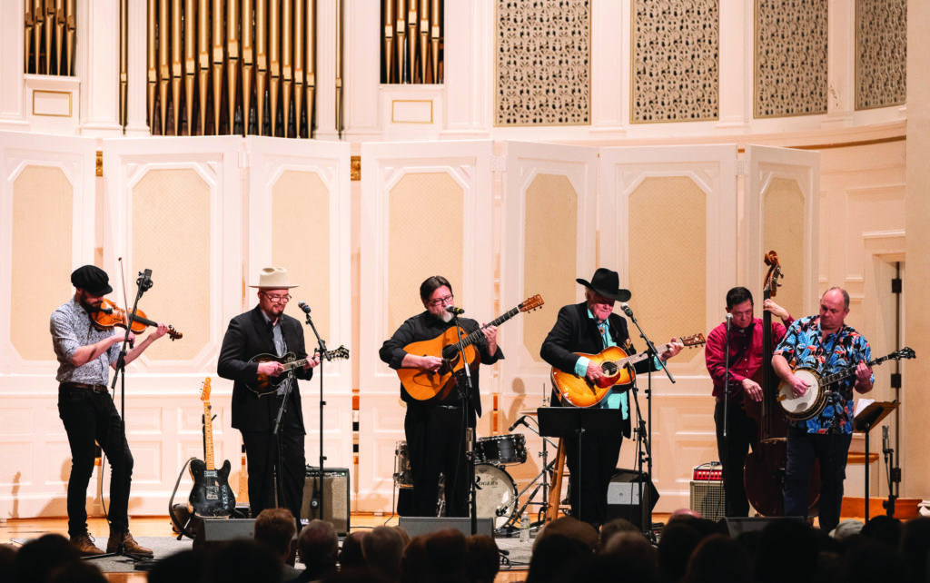 Peter Rowan with Appalachian Swing (2/17/23) in Swasey Chapel on the campus of Denison University for the 50th anniversary of Muleskinner Live.  Left-Right: Chase Potter-fiddle, Hayes Griffin-Mandolin, Adam Schlenker-guitar, Peter Rowan-guitar, George Welling-bass, Todd Sams-Banjo  //  Photo by Lyndsey McCutchan
