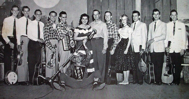 The cast of the Old Dominion Barn Dance, ca. February 18, 1956. Left to right: Allen Shelton, Roy Russell, Curley Howard, Irving Gurganus, Buster Puffenbarger, Sunshine Sue, John Workman, Zag Pennell, Janis Martin, Audie Webster, Earl Webster, and Carl Butler. Comedian/bass player Joe Phillips aka Flapjack sits at front. Photo courtesy of Matt Levine.
