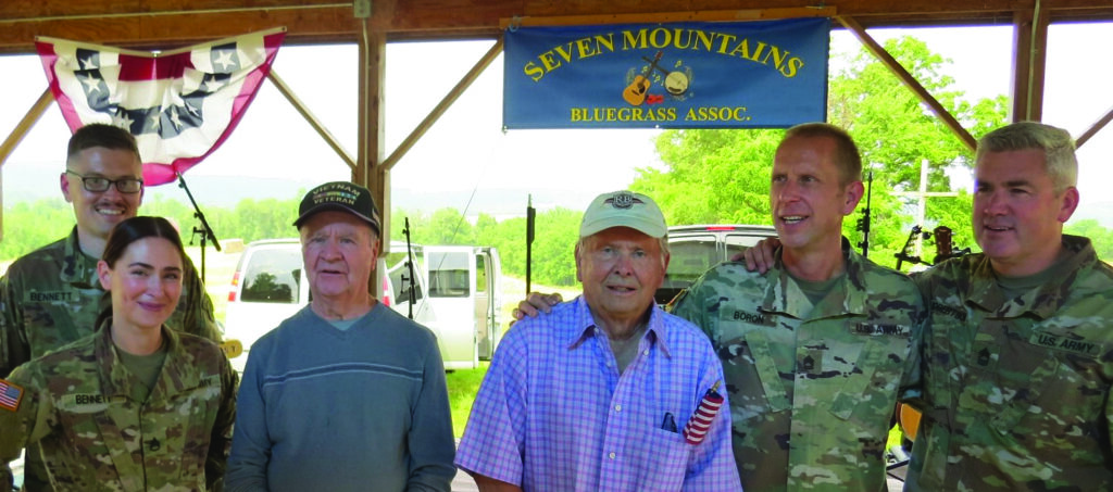 Walt Crider (left) and Dick Beckley (right) are joined by members of the Six-String Soldiers U.S. Army Field Band at a June 2023 concert. // Photo by Dave Nesbit