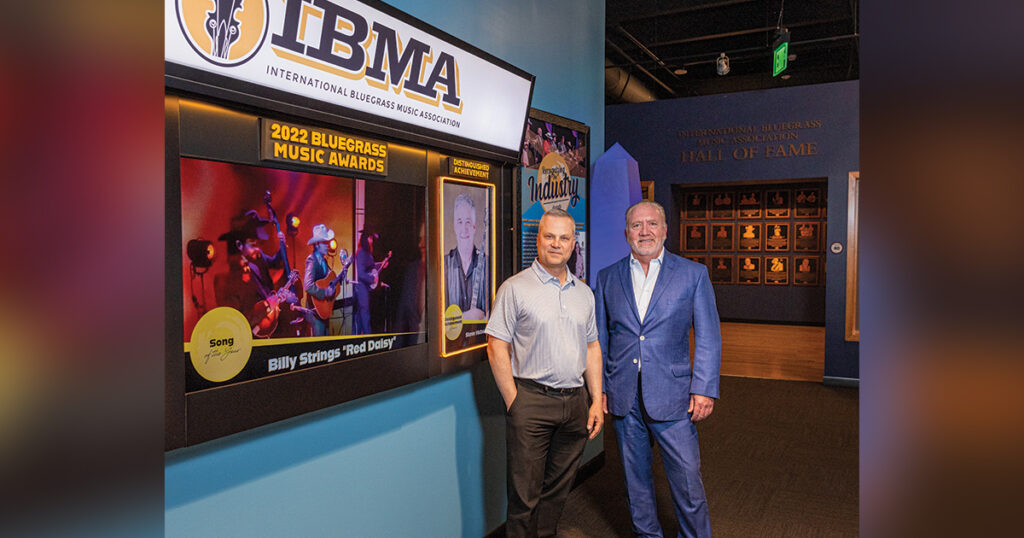 The New IBMA Exhibit at the Bluegrass Music Hall of Fame and Museum. The Museum Executive Director Chris Joslin (left) stands with Mike Simpson, former IBMA Board Chairman. // Photo by jamie plain