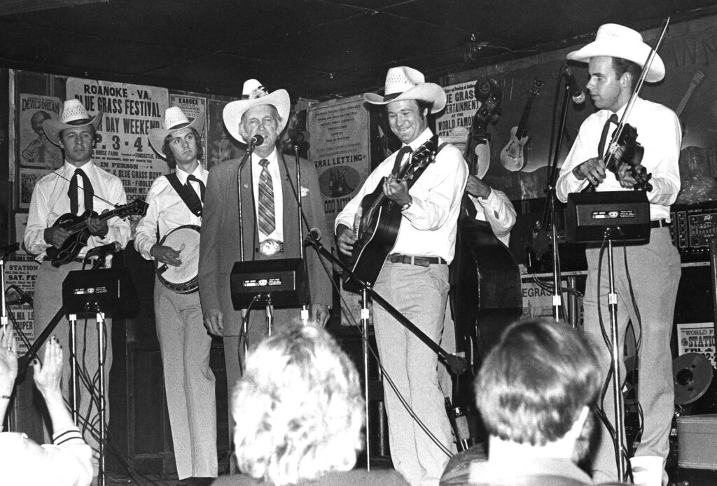 The Johnson Mountain Boys with Bill Monroe: (left to right)—David McLaughlin, Richard Underwood, Bill Monroe, Dudley Connell and Eddie Stubbs.