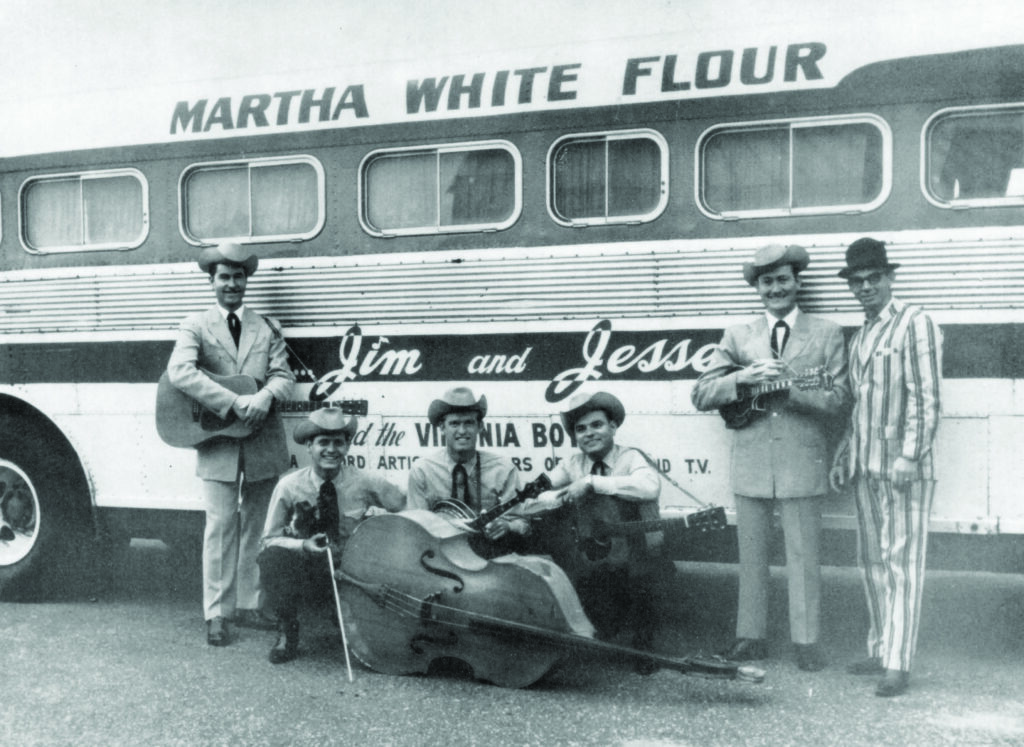 Jim McReynolds, Jimmy Buchanan, Allen Shelton, Don McHan, Jesse McReynolds, and Dave Sutherland in front of former Flatt & Scroggs touring bus, late 1962