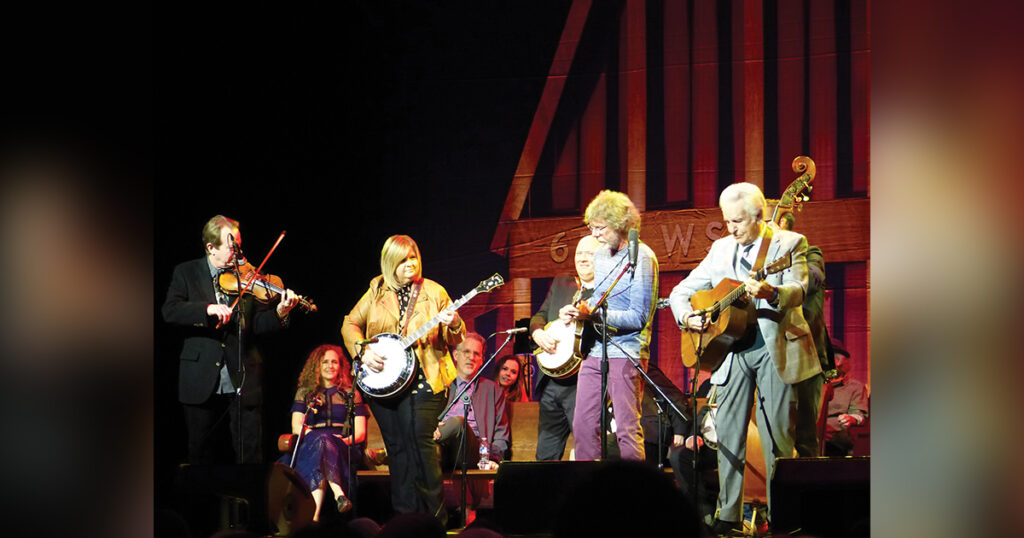 Some of the performers helping celebrate Earl’s 100th Birthday: (left to right) Stuart Duncan, Abigail Washburn (seated), Gena Britt, Bryan Sutton (seated), Sierra Hull (seated), Jim Mills, Sam Bush and Del McCoury. Photo by Gary Hatley