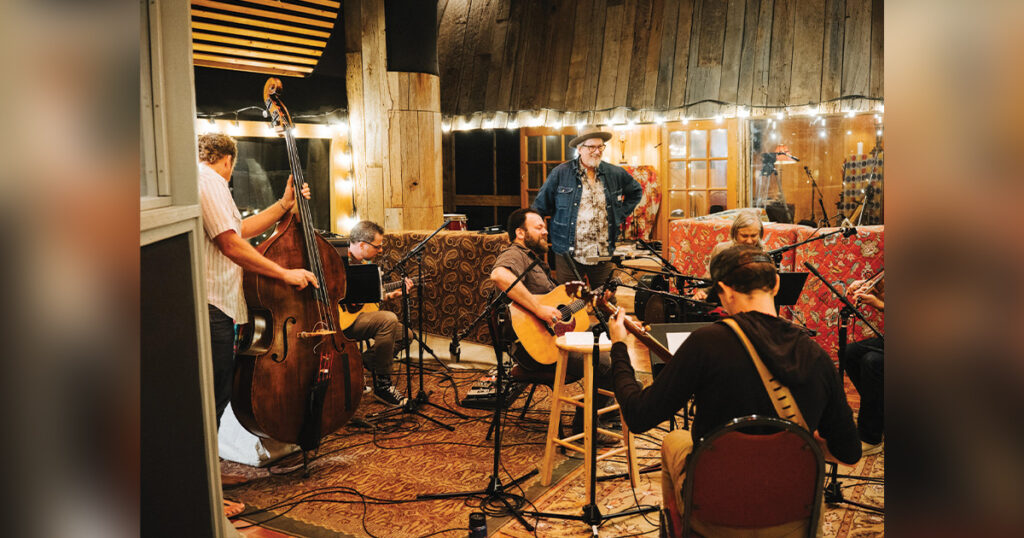 Travis Book, Andy Falco, Cris Jacobs, Jerry Douglas, Chris Pandolfi (with back to camera) and Andy Hall in the studio. // Photo by Joshua Black Wilkins