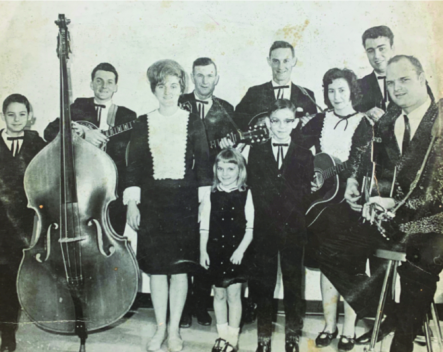 An early photo of the Sally Mountain Show: Back row (left to right): Rick Vincent, Johnny Vincent, Bill Vincent, Pearl Vincent, Phil Baker
Front Row (left to right): Carolyn Vincent, Rhonda Vincent, Joe Vincent, Kathryn Vincent and Boyd Halford. Photo Courtesy of Rhonda Vincent