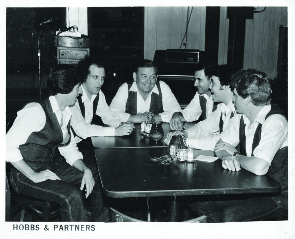 Hobbs and Partners at Partners II Restaurant  (left to right) Kevin Church, Dave Goldman, Arnold Hobbs,  John Paganoni, Rick Whitaker, Bob Cook, 1983.  
Photo Courtesy of Dave Goldman