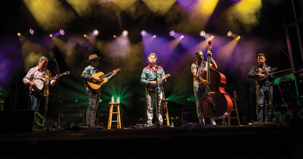 The Travelin’ McCourys performing at ROMP in Owensboro, Kentucky in 2024. (left to right) Rob McCoury, Cody Kilby, Ronnie McCoury, Alan Bartram and Jason Carter. // Photo by Alex Morgan