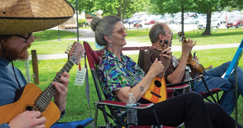 Participants (unidentified) enjoying the 2024 Deer Creek Fiddlers’ Convention. // Photo by Robert Schellhammer