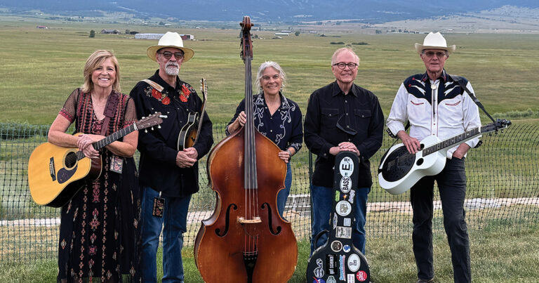 Orchard Creek Band poses in front of the majestic Sangre de Cristo mountain range at High Mountain Hay Fever. // Photo by Vicki Quarles