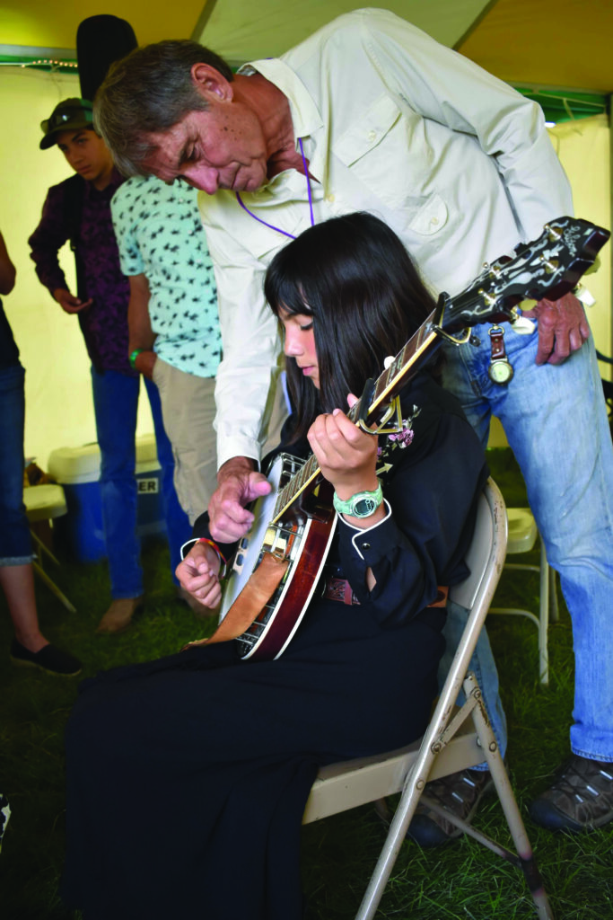 Ron Thomason demonstrates clawhammer techniques for one of the High Mountain Hayseeds at the festival.
Photo by kevin slick