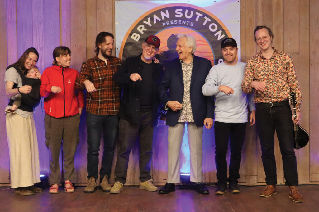  Courtney Hartman, Charlotte Carrivick, Chris Eldridge, Bryan Sutton, Del McCoury, Jake Workman and Michael Daves at Guitar Camp 2024.  // Photo by Lily Sutton