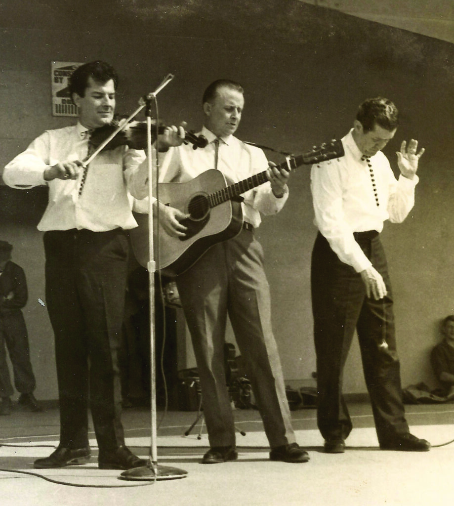 Jim Lunsford fiddles while Roy Acuff does yo-yo tricks during a 1966 USO tour to perform for U.S. military in Vietnam.
Photo courtesy of the lunsford family