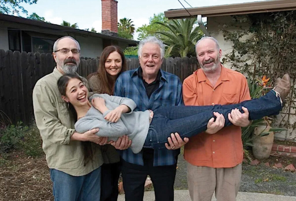 John Reischman, Trisha Gagnon, Peter Rowan and John Kael holding Annie Staninec  //  Photo by Tom Size