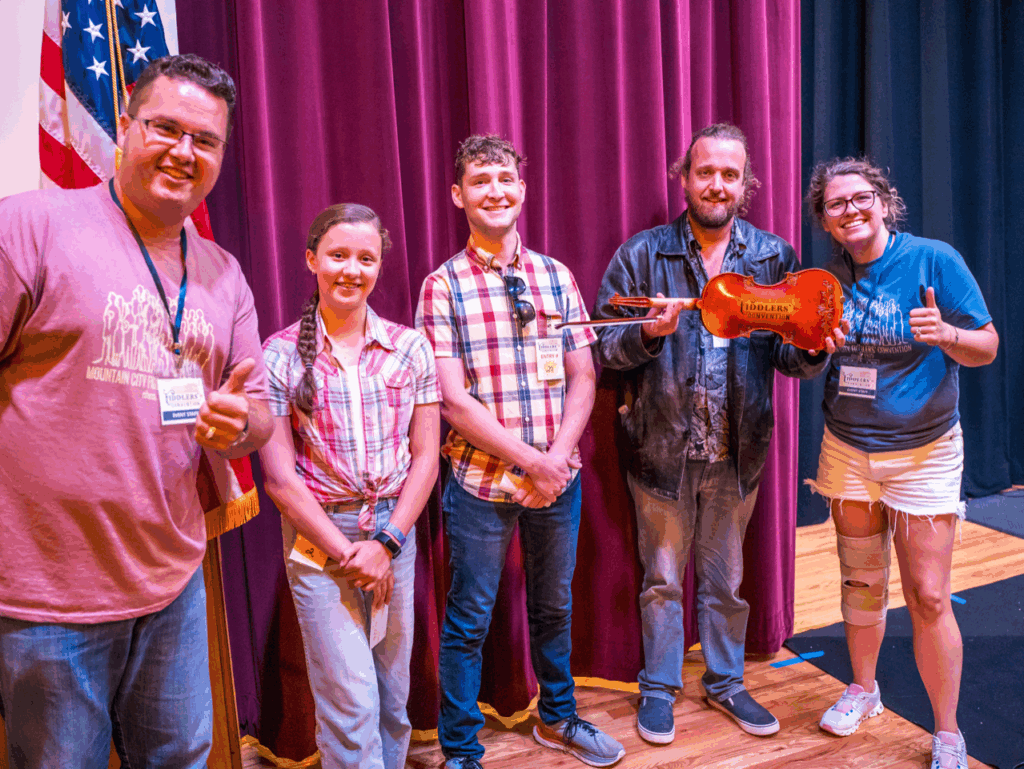 Kody Norris (left) and Mary Rachel Nalley-Norris (right) with the 2024 Fiddle-off winners, Hollace Oaks from Virginia, Cody Bauer from Tennessee, and Timon Veelenturf from The Netherlands.
Photo by Dustin Nelson